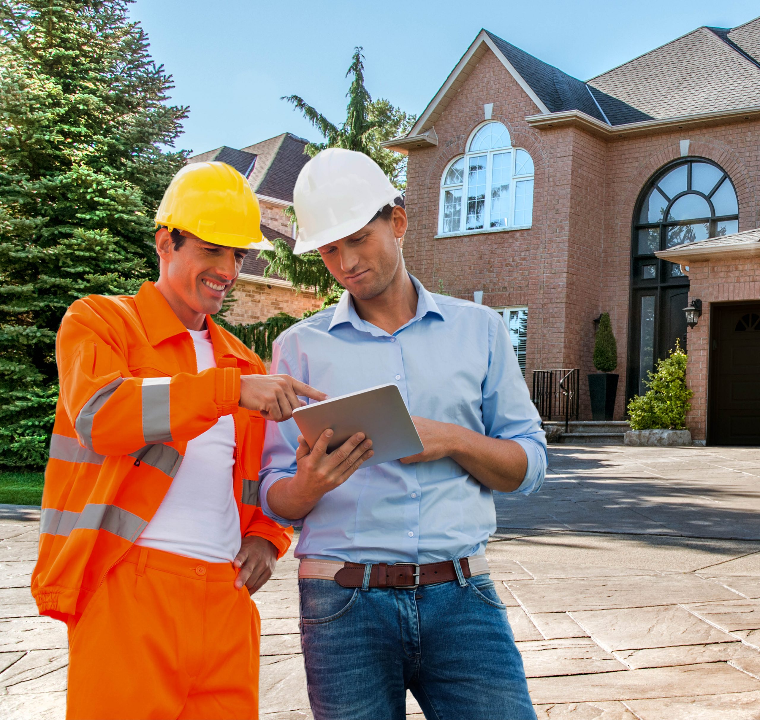 Two men in hard hats reviewing items on a tablet
